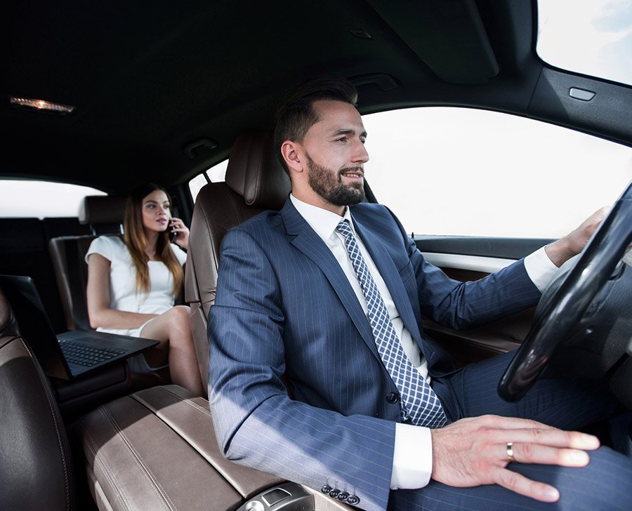 Woman in car with chauffeur