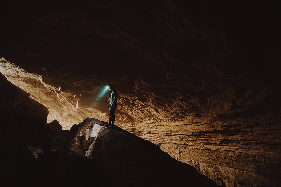 Person exploring a cave