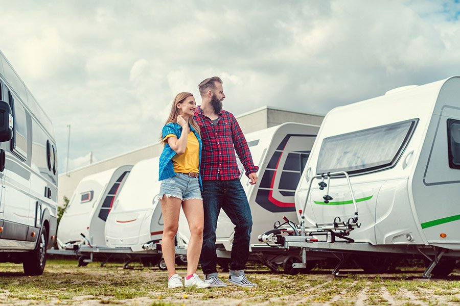 Woman and man choosing camper van