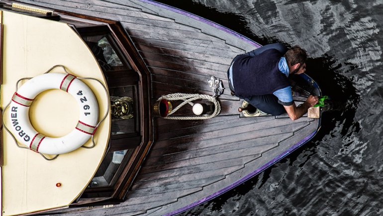 Man cleaning the boat anchor