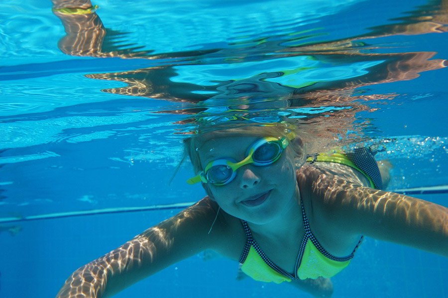 Girl holding breath in pool