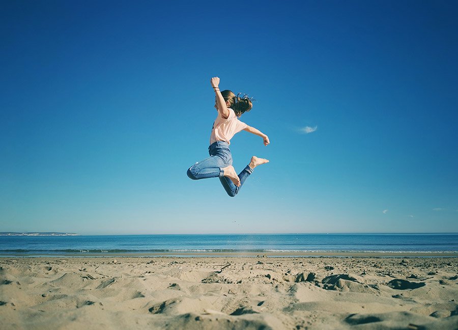 Kid jumping on the beach
