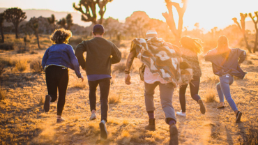 Students running in the desert