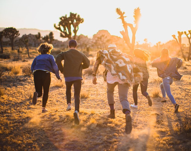 Students running in the desert
