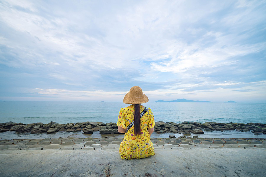Student traveler looking at the sea