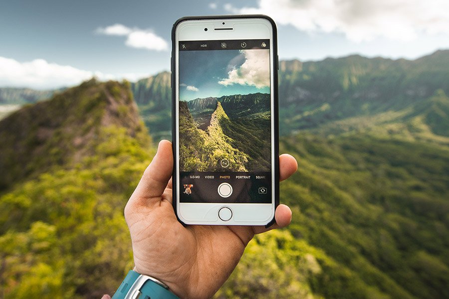 Traveler taking a photo with his smartphone