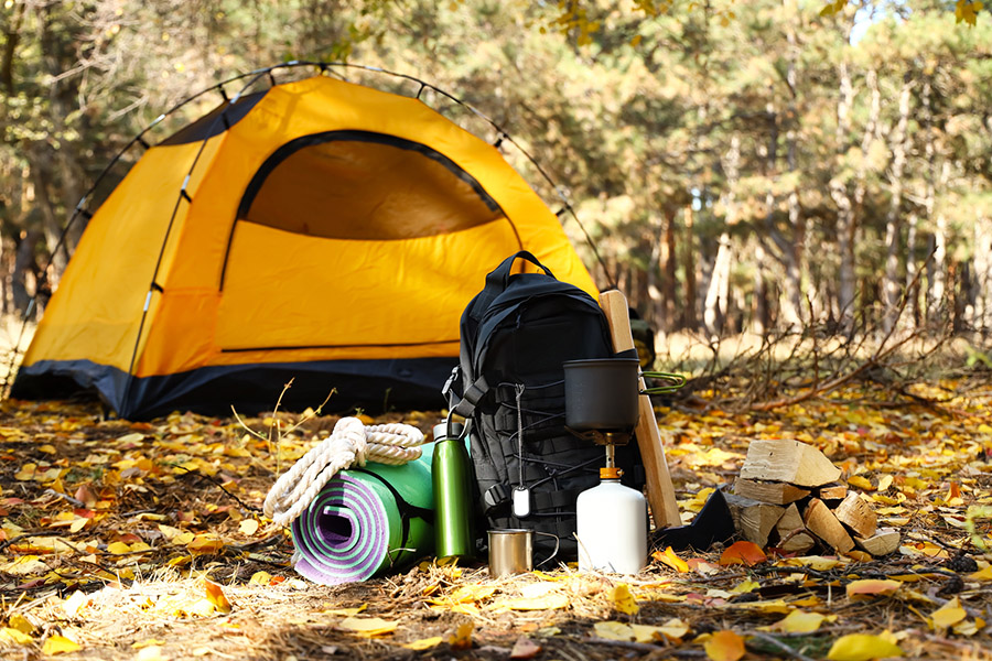 Camping equipment and a tent in the forest