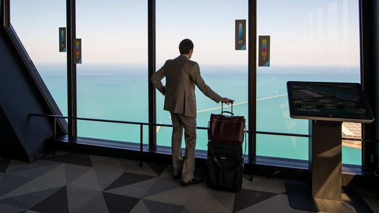 Business traveler looking at the sea