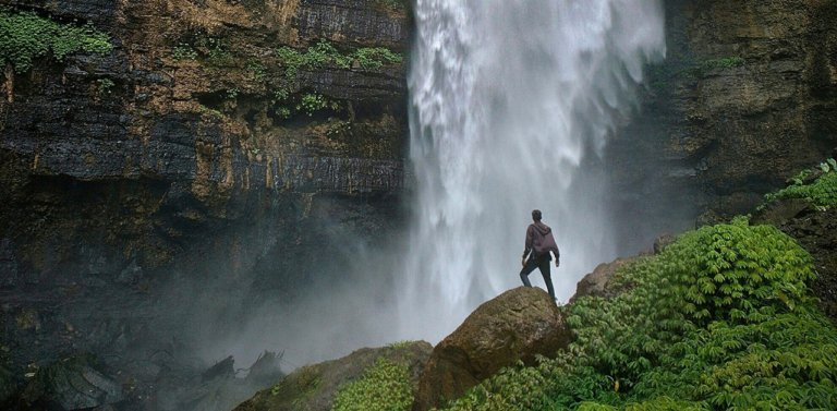 Adventure traveler at a waterfall