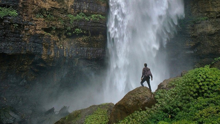 Adventure traveler at a waterfall