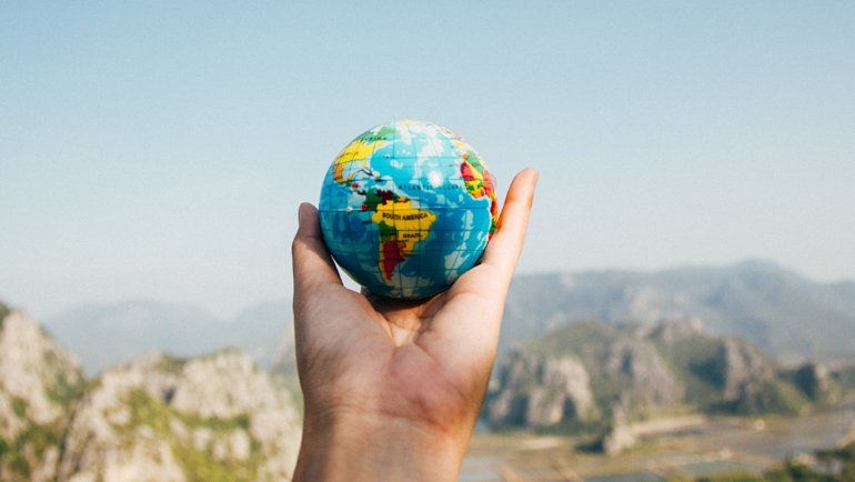 Person holding a globe