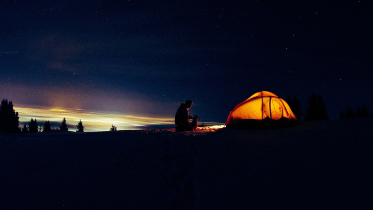person camping at night