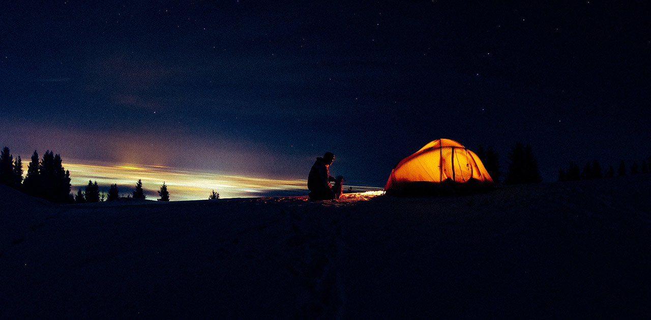 person camping at night