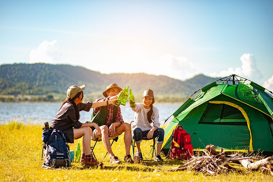 Friends camping near a lake
