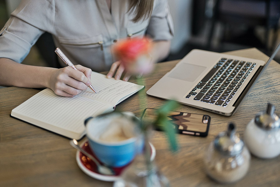 Person writing at a desk