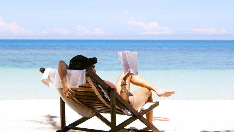 Person reading at the beach