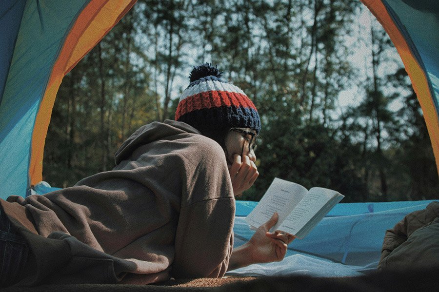 Person reading in her tent