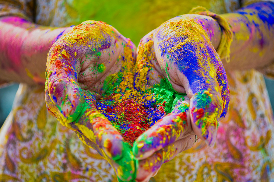 Hands holding color powder
