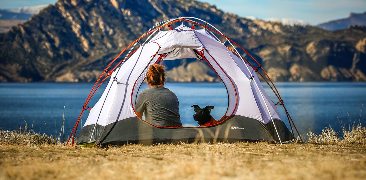 Woman and her dog in a tent