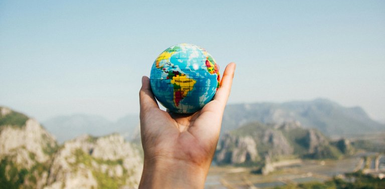person holding a globe