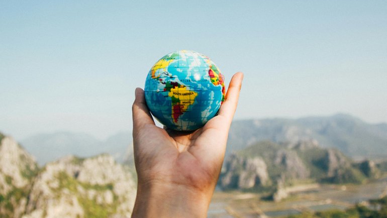 person holding a globe