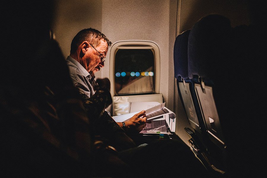 Person reading in the plane