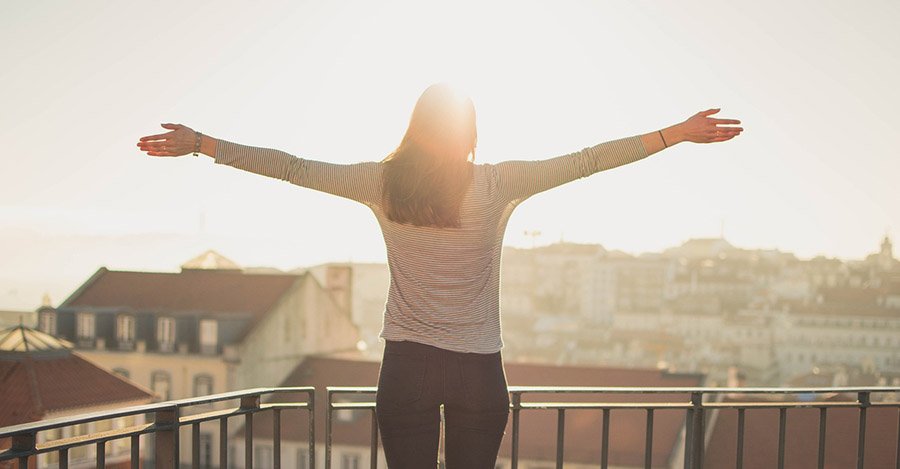 Happy traveler on a balcony