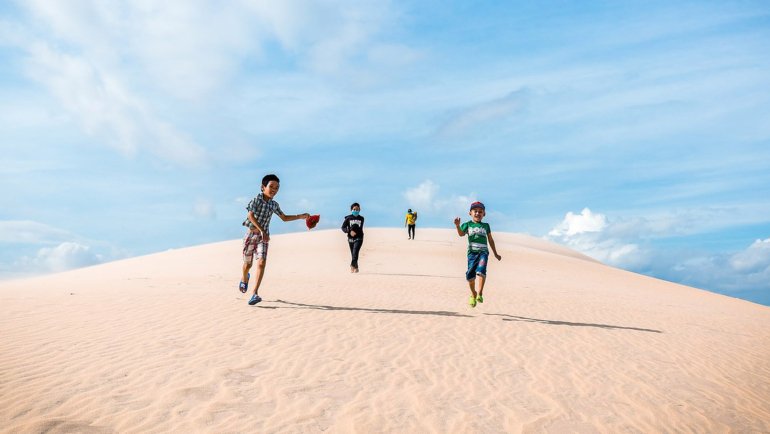 Kids running in the sand
