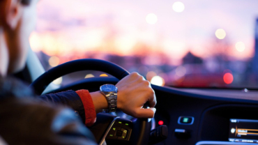Man driving at sunset