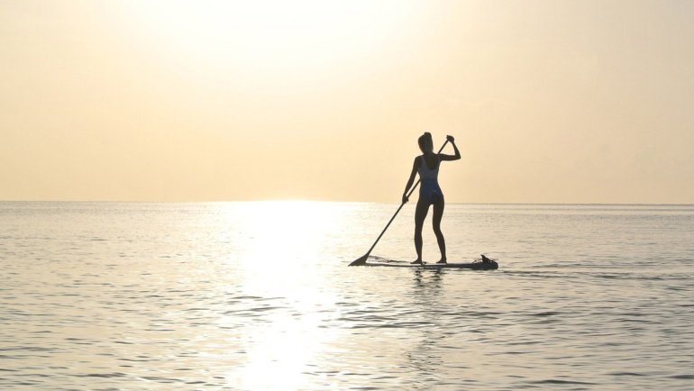 Paddle boarding at sunrise